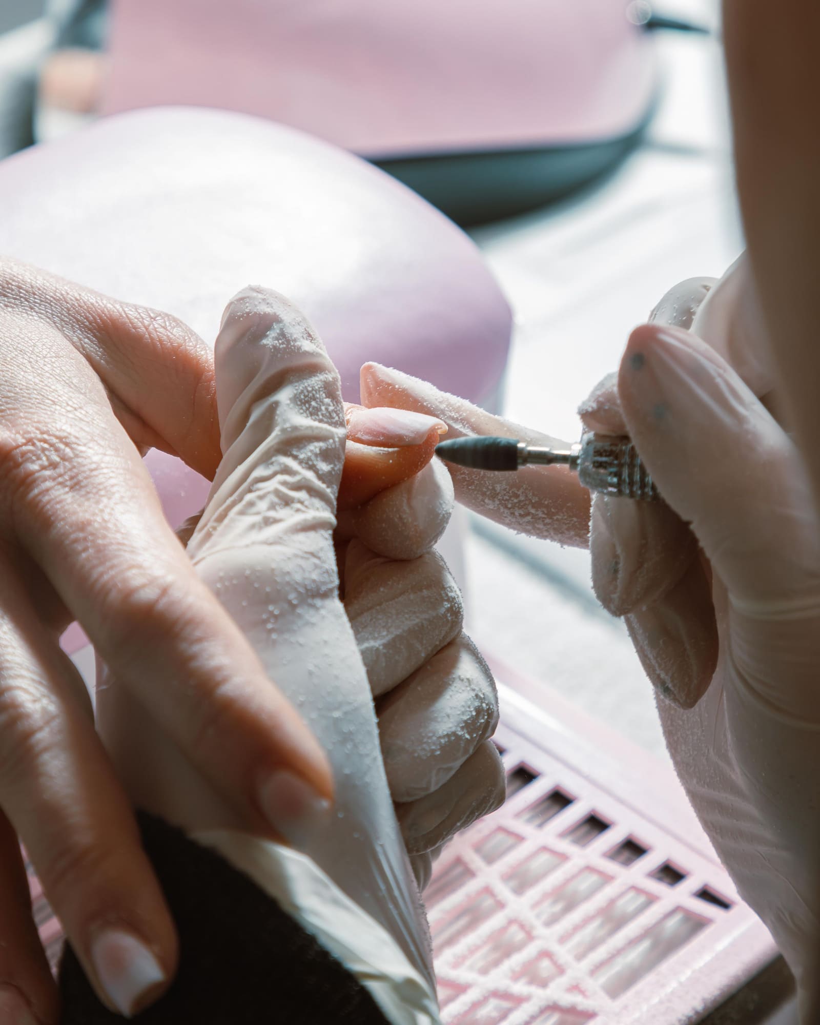 Nail artist shaping a client's nails